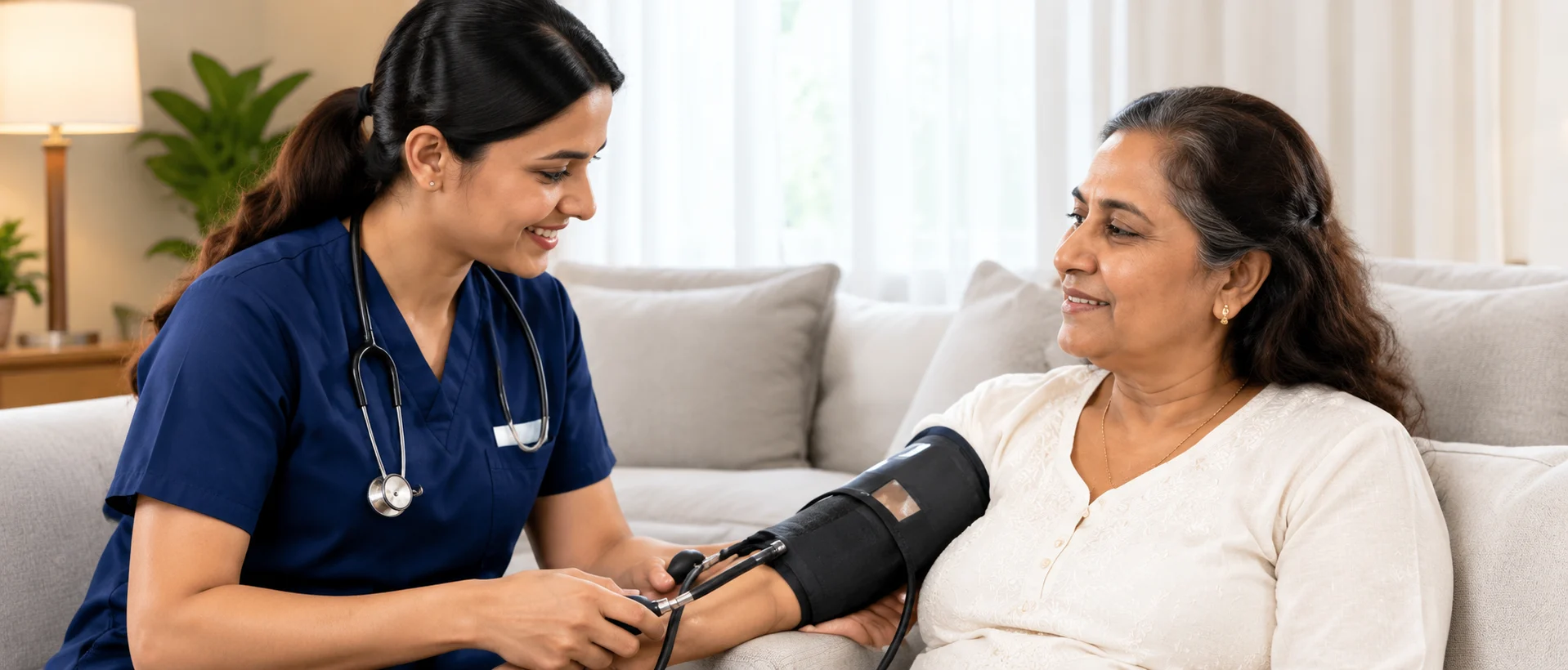 Nurse checking a patient’s blood pressure at home